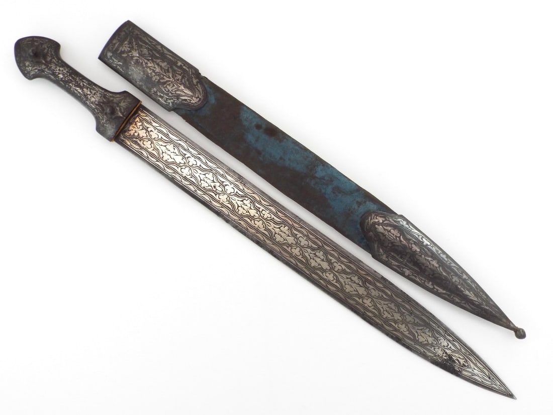 Grand size Ottoman or Caucasian kindjal short sword: An interesting Caucasian or Turkish kindjal with silver etched mounts and silver chiselled decorations to the straight double edged blade. Complete in its scabbard.