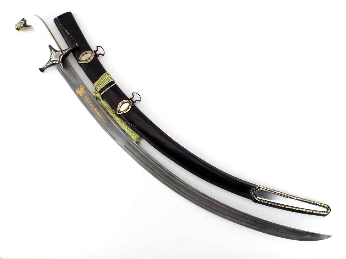 Middle Eastern ISLAMIC Shamshir Sword with Gold Overlay: Curved steel blade presents fullers and gold work panels featuring the translated Quranic inscription, Sufficient for us is Allah, and He is the best Disposer of affairs, in Allah we put our trust. Sh
