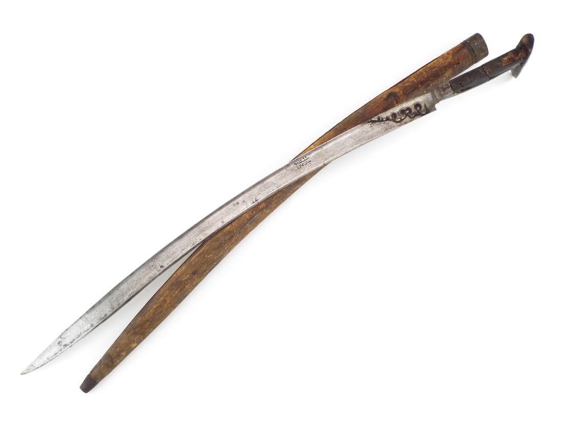Rare Variant Ottoman 18th C. ISLAMIC Yataghan Sword with DAMASCUS STEEL: Recurved blade shows deep set serpentine chiseling and Islamic inscriptions including an owner name reading Halil Agha, fuller with damascus pattern. Surface exhibits localized spotting and dark age p