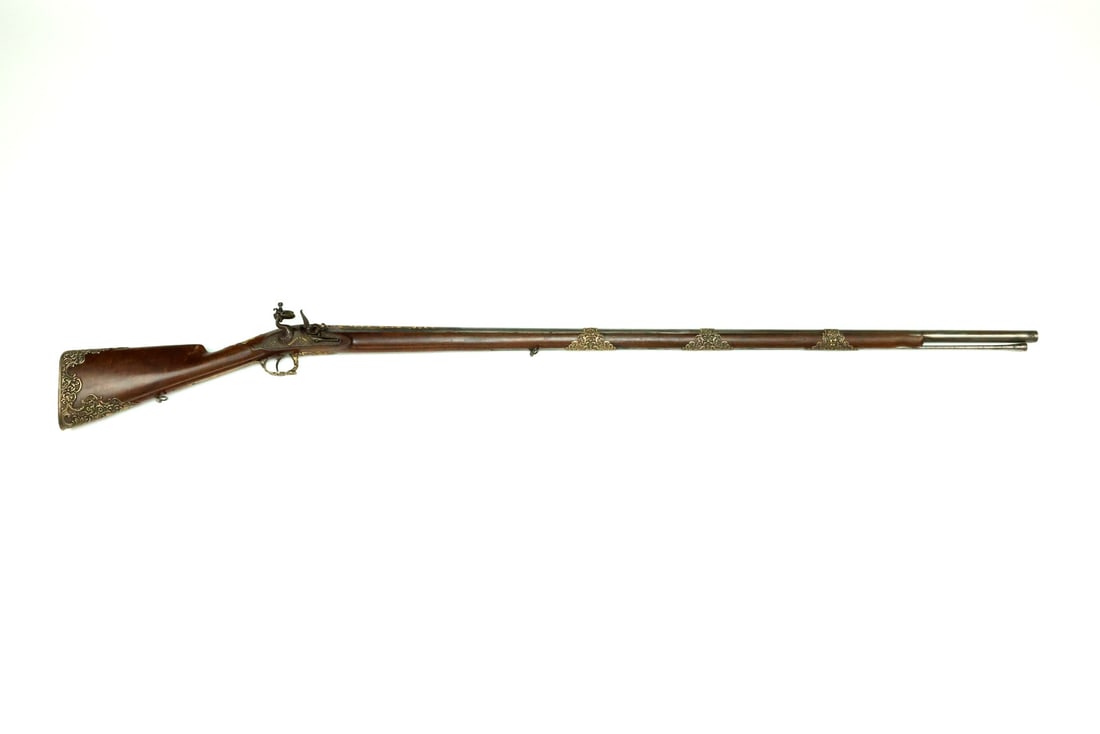 Excellent French 19th C. Flintlock Musket By MANCEAUX A PARIS with Gold Inlays & Chased Brass: Fine smoothbore barrel showing crisp gold floral scrolls and stamped inventory number D 224 exhibiting minor surface oxidation and localized staining to the bright steel flats. The lock plate