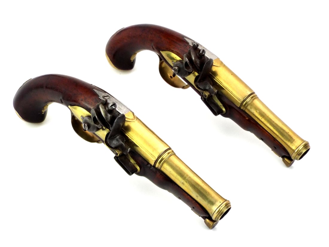 European 19th C. Flintlock Pistol Pair with BRASS FURNITURE: Pair of matching flintlock pistols with brass barrels and mounts retaining dark finished stocks, functional lock mechanisms with expected age wear and oxidation, brass side plates, trigger guards, but