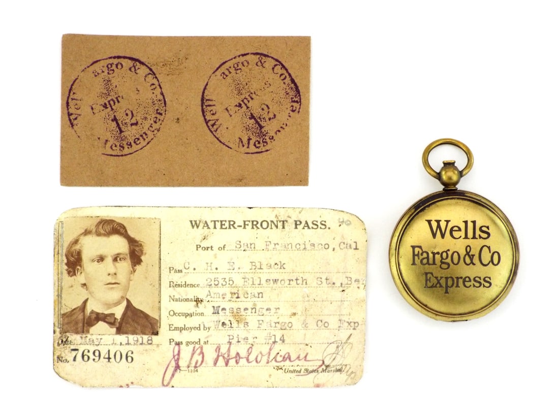 Wells Fargo Express WATERFRONT MESSENGER PASS & HAND STAMP: issued to messenger C. H. E. Black, comprising a paper pass showing edge wear, minor staining and ink signatures, a circular cardboard card with crisp purple ink stamps and an oval brass pocket