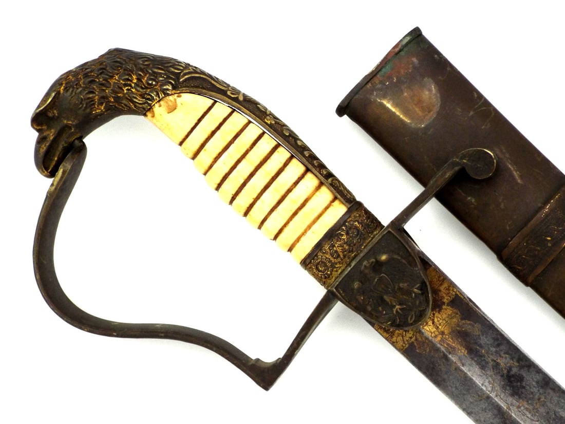 War of 1812 Officer Sword with RARE METAL Scabbard: Single edged blade features hand etched trophies and floral sprays with gold wash remnants, showing honest oxidation and an edge nick. The hilt with moderate play, retains a cast brass American eagle