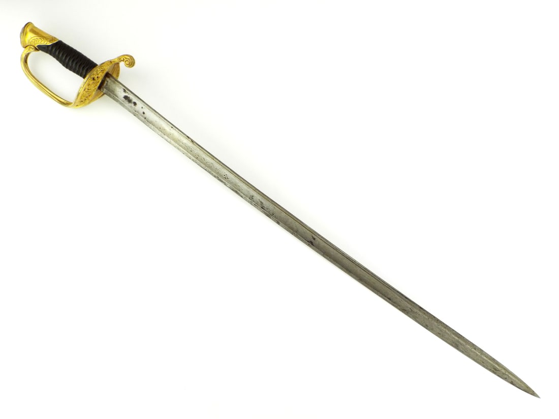 American Civil War Infantry Officer Sword Gilt Brass Guard: Straight blade with twin fullers showing localized peppering and dark patina, spine hand engraved with the outfitter name. Gilt brass pierced guard displaying floral scrollwork with typical gilt wear,