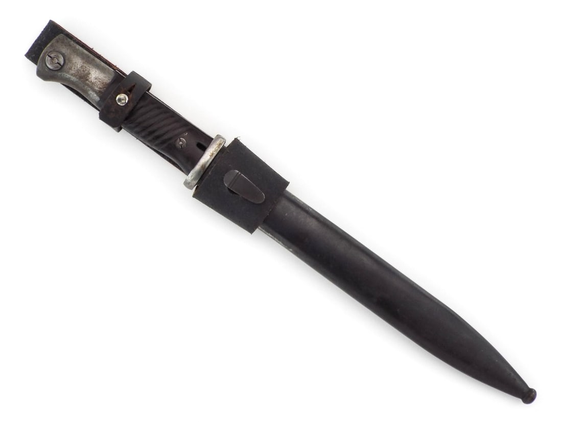 German WWII K98 Bayonet: Blued steel blade By Alcoso, exhibiting minor finish wear and crisp Coppel G.m.b.H. trademark opposite serial number 7825b. Hilt features pommel with operational release button and dark, diagonally gr
