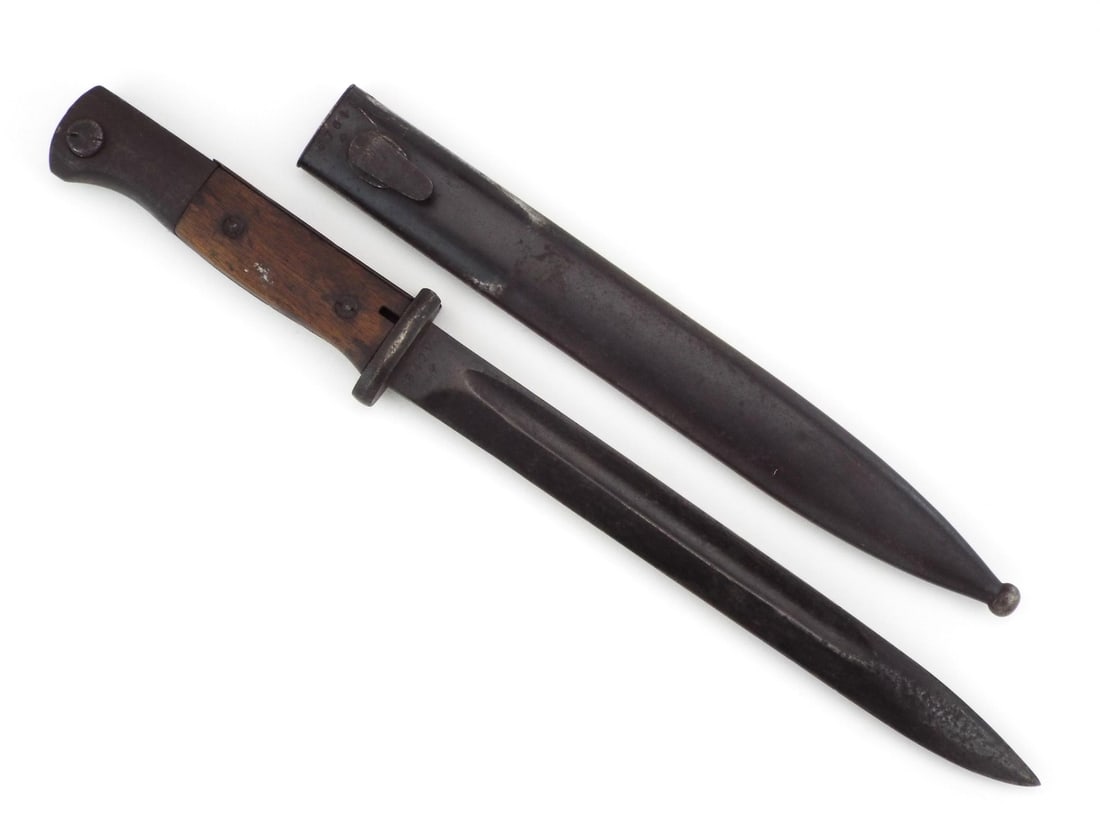 German WWII K98 Bayonet: Single edged blade featuring a deep fuller, blued finish showing honest battlefield wear and ricasso marked 5429q and maker code 42 asw - Horster. The hilt is solid with weathered wood grip scales sec
