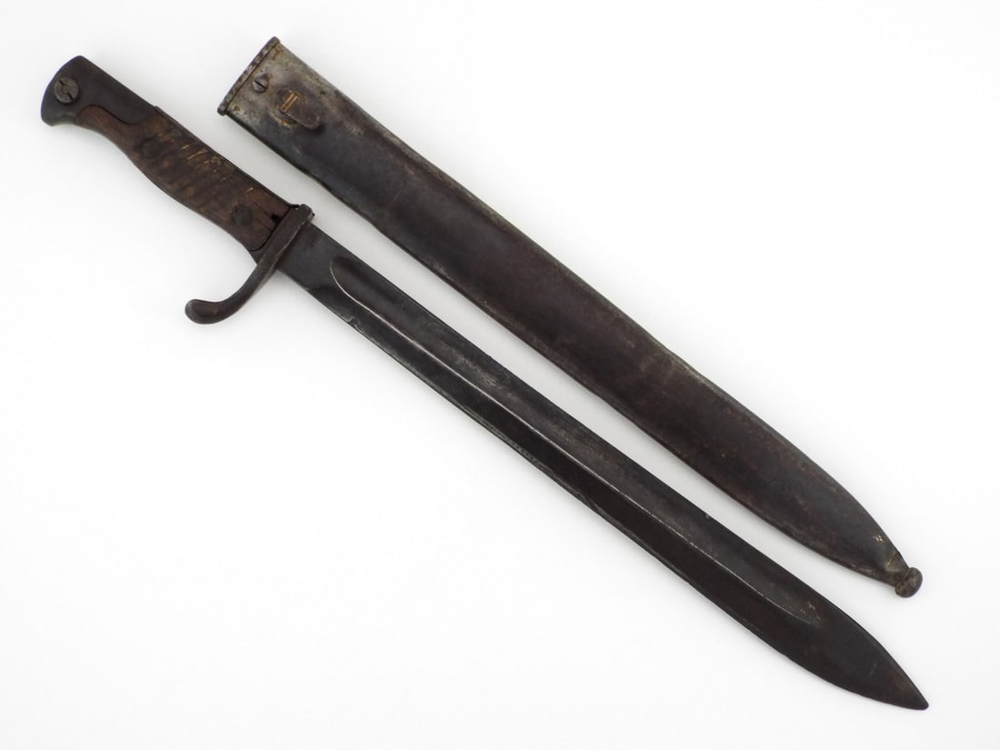 German WWI Butcher Bayonet: Blade shows light patina with a wide, cleaver like tip, stamped by Simson & Co. Suhl and spine dated 16 under a crown. Grooved wood grips exhibit a distinct gouge near the upper screw, fitted with a s