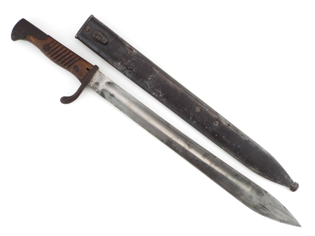 German WWI Butcher Bayonet: Fuller grooved butcher style blade displays localized graying and surface oxidation, stamped with Solingen maker WKC on ricasso. Wood grip scales show field wear and minor bruising, secured by two pin