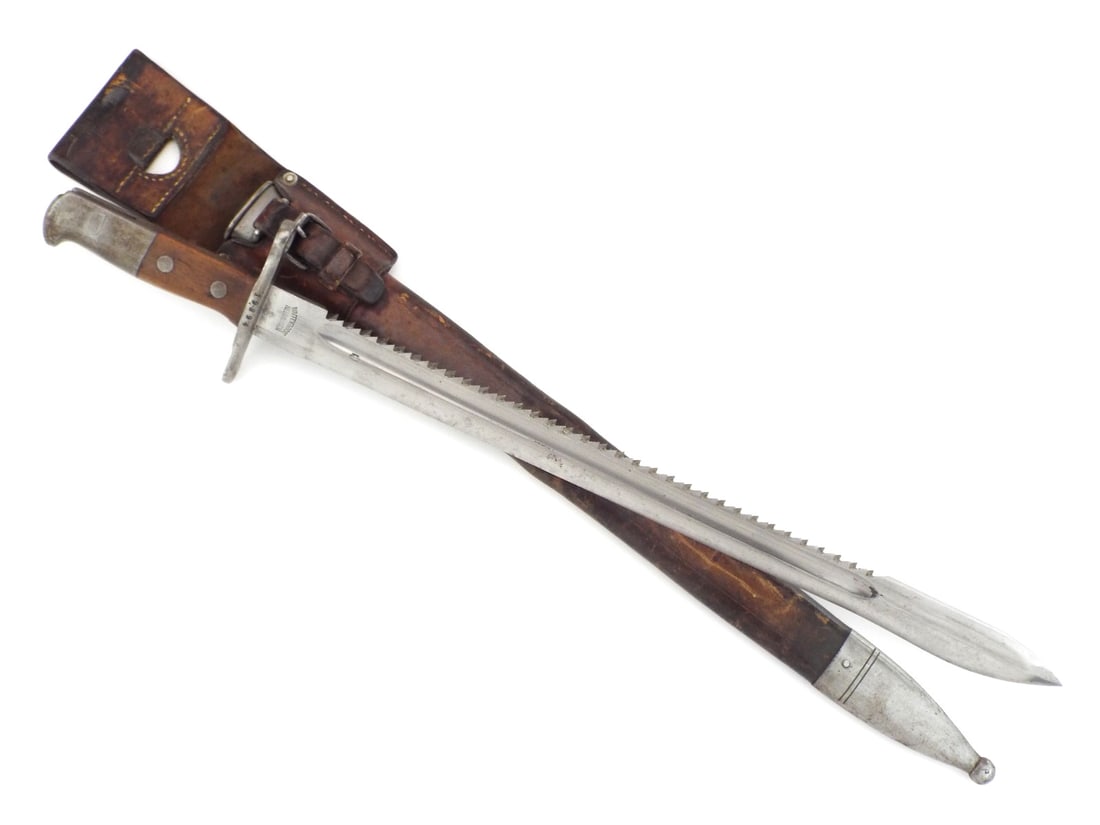 Swiss WWI Pioneer Bayonet Sawback Blade By WAFFENFABRIK NEUHAUSEN: Full length sawback blade shows clean fuller and WAFFENFABRIK NEUHAUSEN ricasso stamp with Swiss cross. Bright finish exhibits light surface freckling and storage wear. Wood grips remain solid with mi