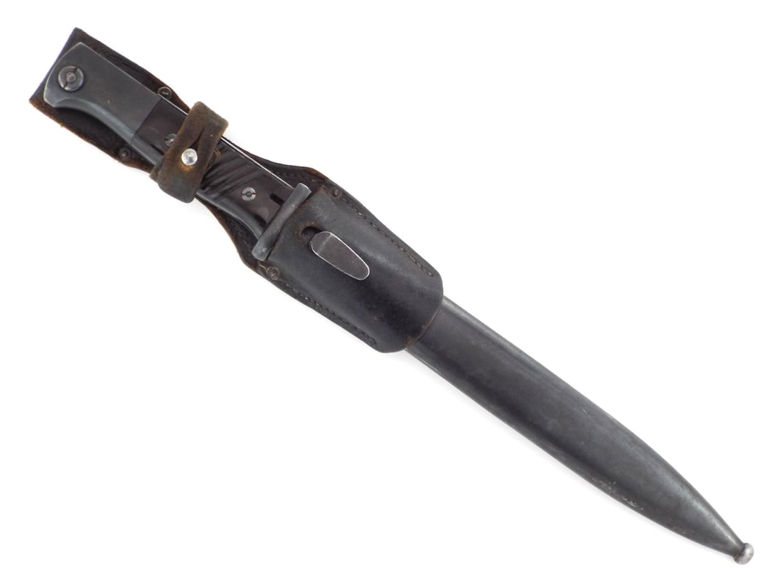 German WWII Karabiner 98k Bayonet By PAUL WEYERSBERG with Matching Number Scabbard: Highly preserved S84/98 III bayonet shows a deep blued finish on the single edged fuller blade. Grooved dark Bakelite grips are tightly secured to the hilt. Matching blued metal scabbard retains crisp
