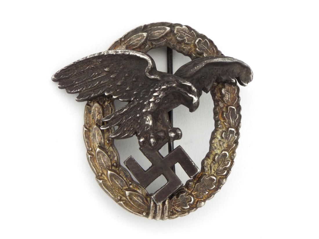 German WWII Luftwaffe Observer Badge By Rare Maker PAUL MEYBAUER with PM Mark: Zinc construction shows distinct age wear and loss of finish to the silvered oval laurel and oak leaf wreath. Darkened zinc eagle is firmly secured to the wreath body via two solid reverse rivets. Rev