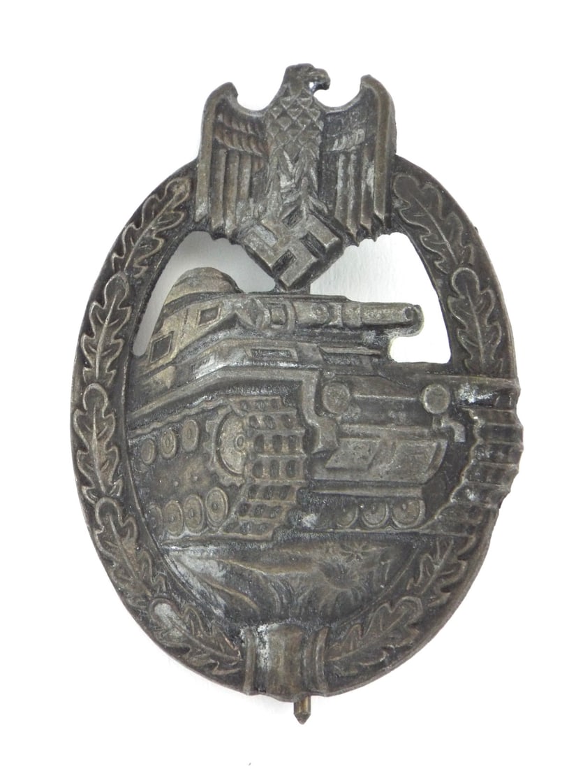 German WWII Tank Assault Medal By PAUL MEYBAUER Silver Wash Zinc: Die struck zinc body retains faint traces of its silver wash finish, displaying a dark grey aged patina with minor surface oxidation on the obverse detailing. Reverse exhibits an integral hinge and ca