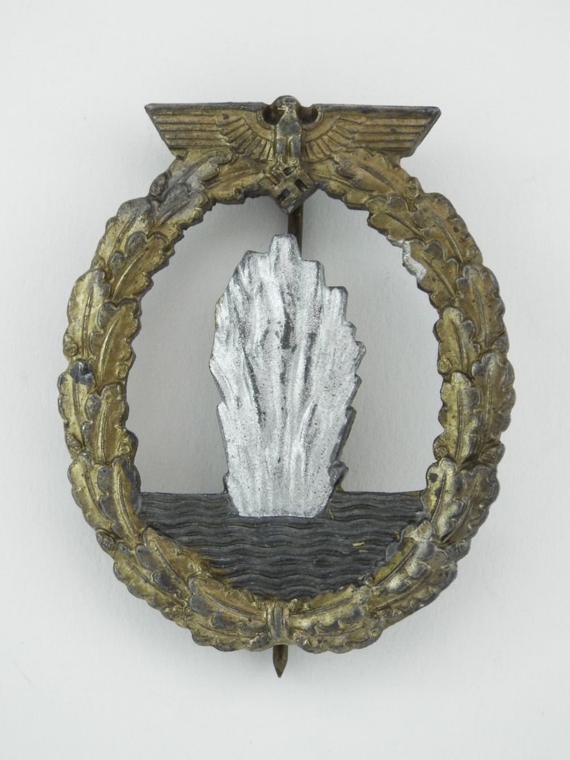 German WWII Minesweeper War Badge By RUDOLF SOUVAL Vienna: Die struck body retains muted gilt finish on wreath with separate silvered water spout insert showing light high point wear. Reverse displays explicit R.S. maker stamp with integrated barrel hinge, fu