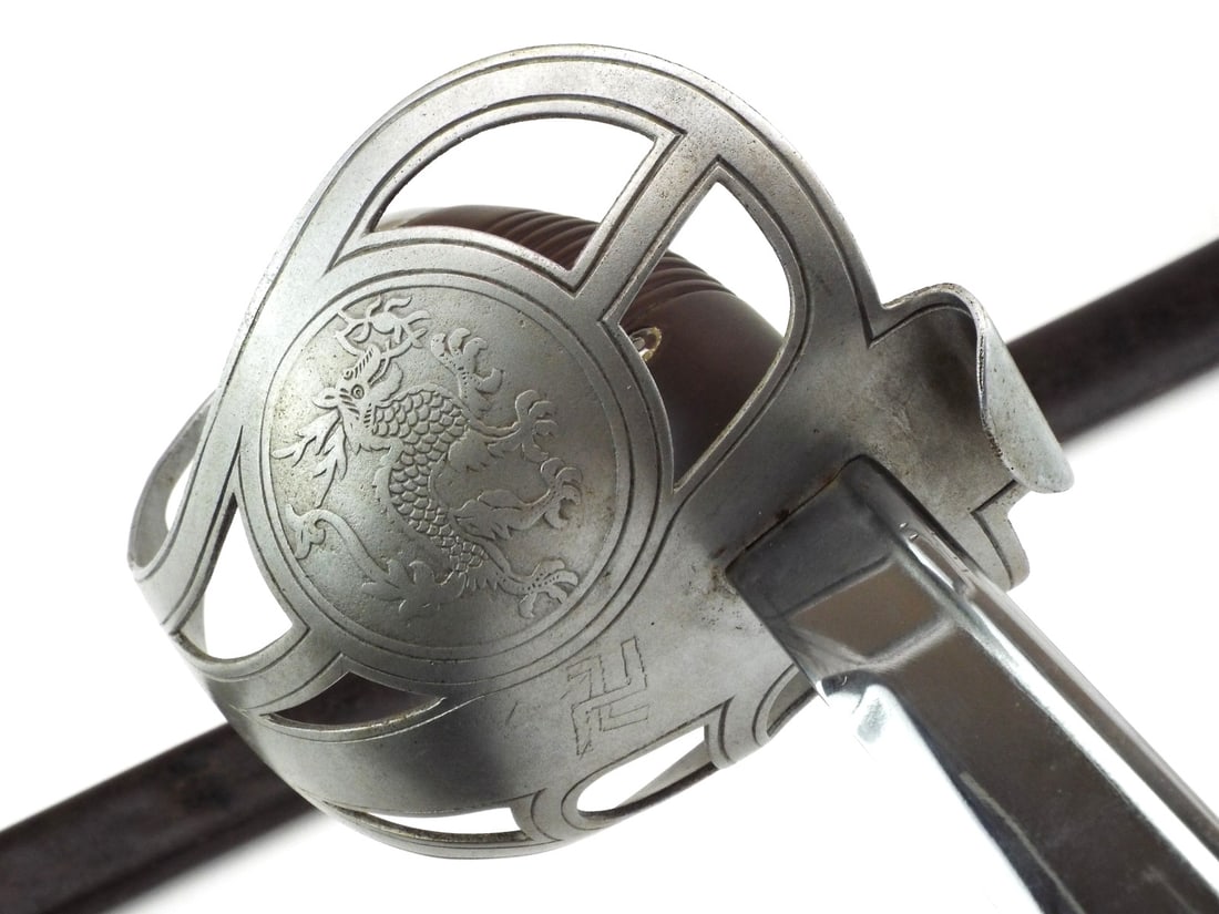 Very Rare German Colonial East Asian Expeditionary Corps Sword by HORSTER SOLINGEN: Slightly curved nickel blade shows minor surface wear with clear E&F HORSTER SOLINGEN maker mark. The steel P-hilt guard features a pierced Imperial Chinese Dragon and a hand cut German Ensign. Brown 