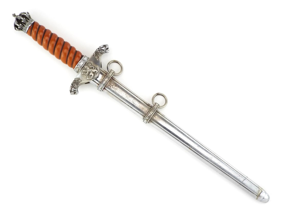 Bulgarian Kingdom WWII OFFICER DAGGER Crown Pommel: Blade shows heavy salt and pepper oxidation obscuring the engraved motto translating to God is with us. Orange celluloid spiral grip remains tight with intact wire wrap, flanked by a lion head crossgu
