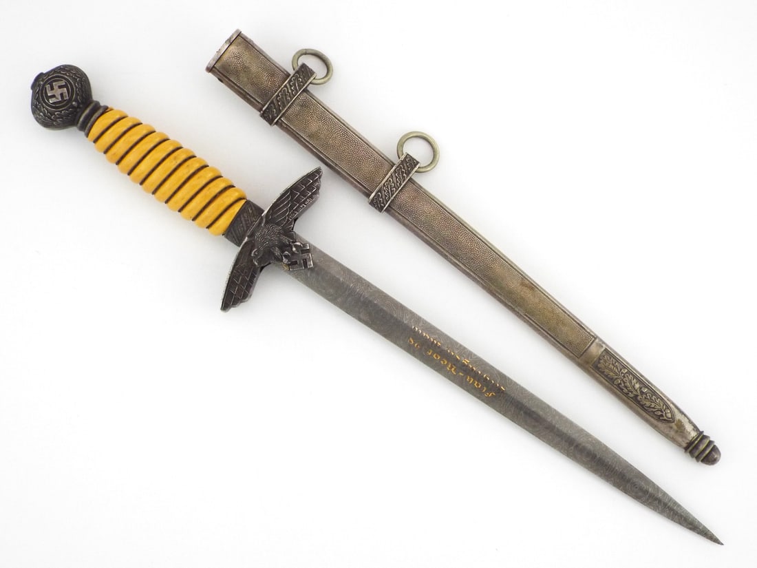 German WWII 2nd Model Luftwaffe Officer Dagger By CARL EICKHORN Solingen with Portepee: Bright double edged steel blade shows light surface scuffing and runner marks with stamped manufacturer logo. Deep orange celluloid grip remains tight with intact wire wrap, flanked by an aluminum eag