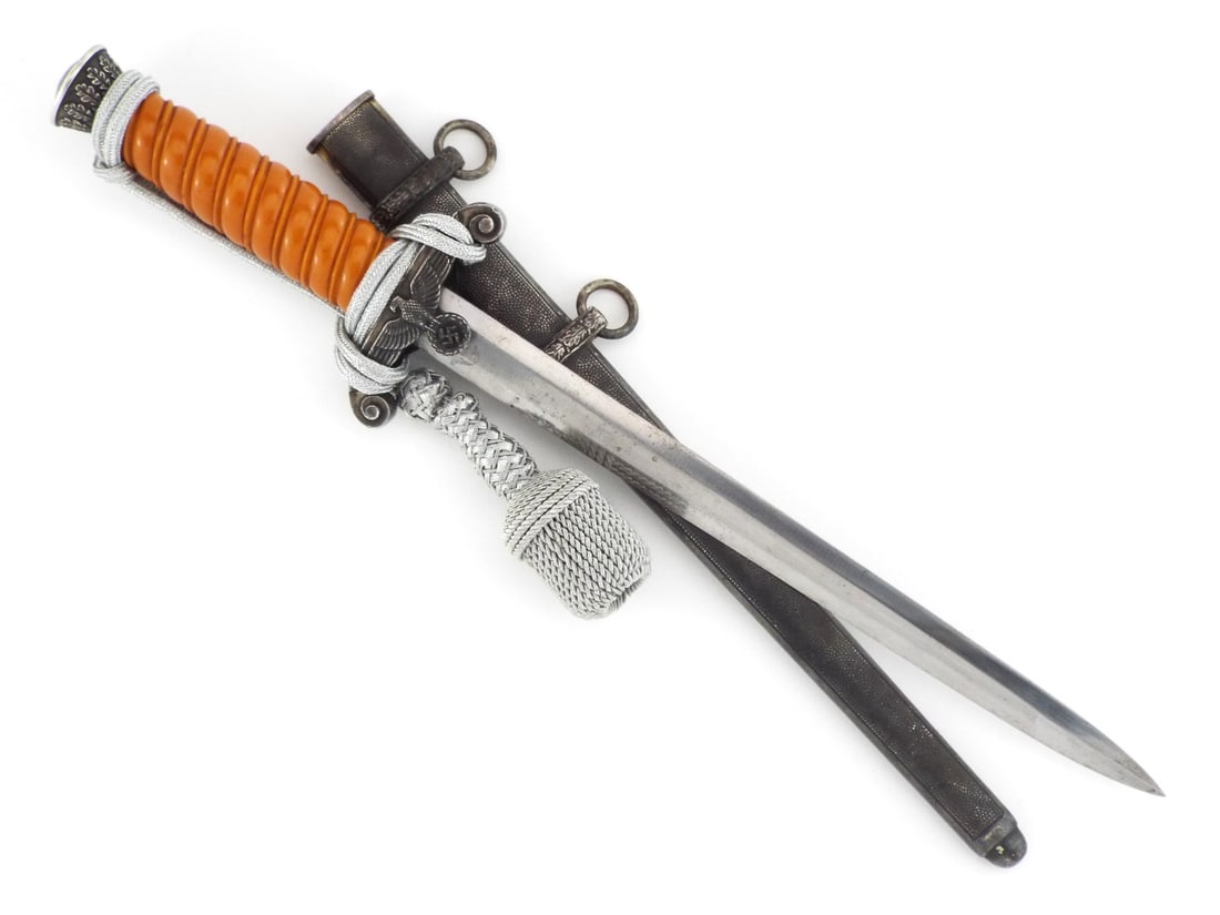 German WWII Army Officer Dagger By CARL EICKHORN SOLINGEN with Silver Bullion Portepee: Double edged blade retains factory polish with minor runner marks and light peppering, displaying the standard Eickhorn squirrel trademark on the ricasso. The zinc alloy crossguard eagle and oak leaf 
