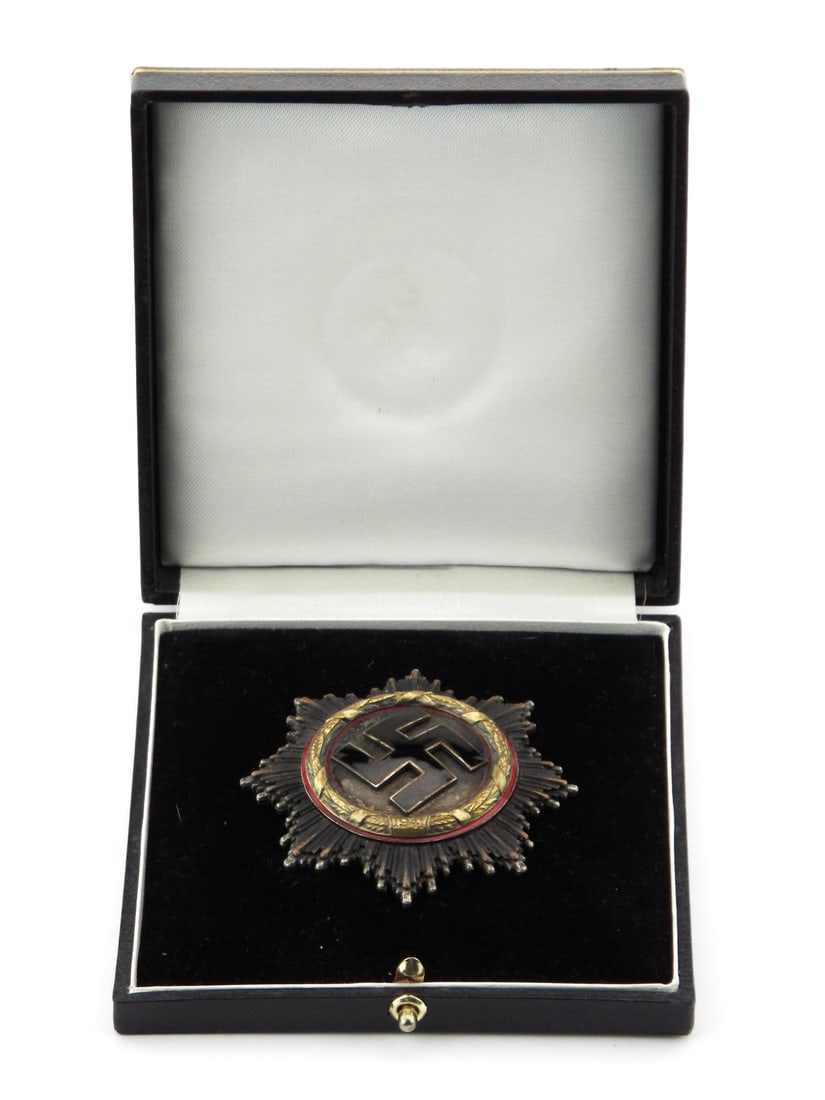 German WWII Encased German Cross Medal in Gold By C.E. JUNCKER with Engraved Reverse: Eight pointed starburst medal body displays expected age toning to the silvered rays with minor enamel chips to the central emblem, retaining bright gilded laurel wreath dated 1941. Reverse exhibits h
