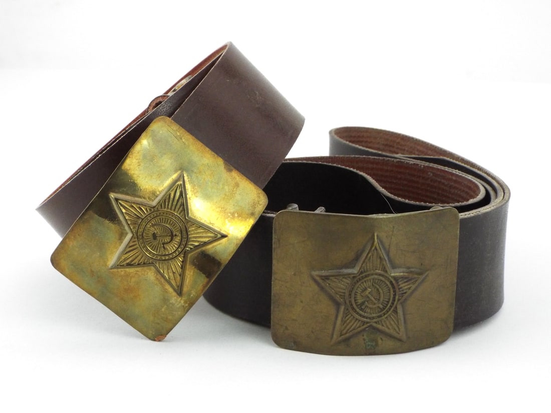 Pair of Soviet Cold War Red Army NCO Field Belts with BRASS BUCKLES & Kirza Straps: Pair of Soviet Cold War era NCO field belts features stamped brass plate buckles depicting the classic five pointed star with hammer and sickle emblem. Buckles show light surface wear and minor tarnis