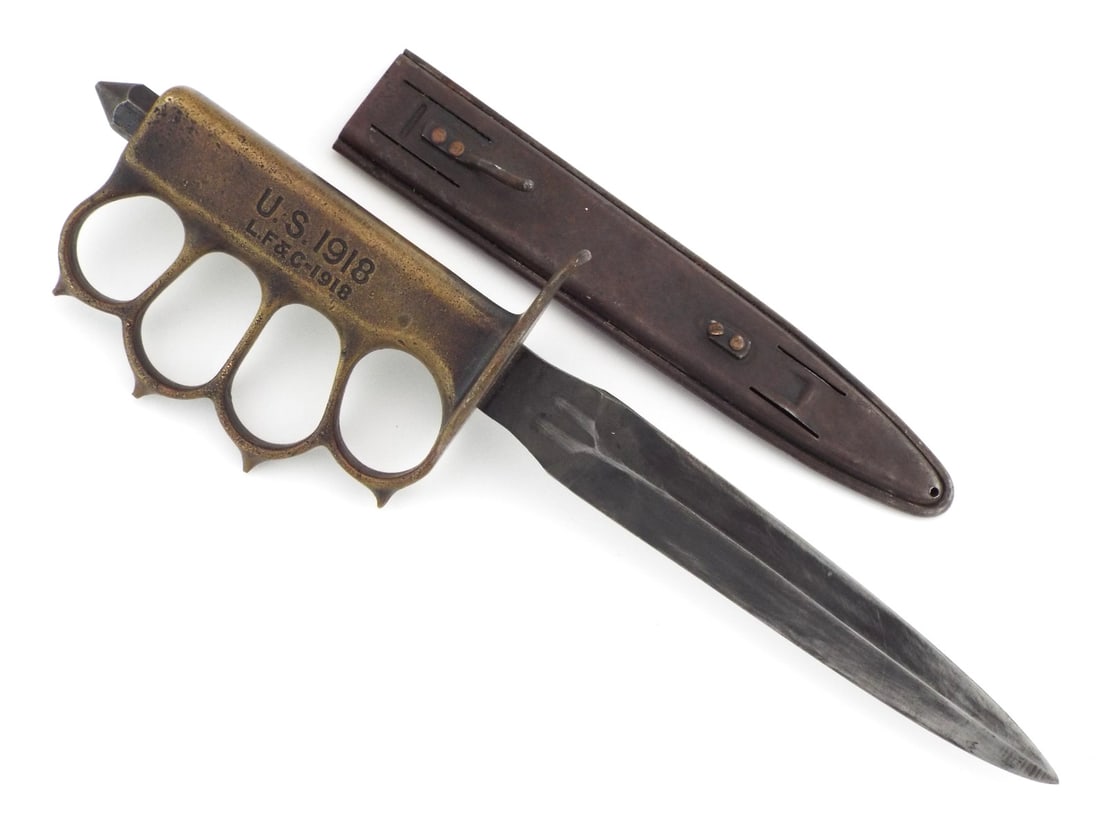 US WWI Trench Knuckle Dagger By L F & C with RARE SCABBARD: Double edged dagger blade retains fmost of the actory black finish with minimal wear. Cast bronze knuckle bow handle features well defined spikes, showing an even olive patina with crisp stamped U.S. 