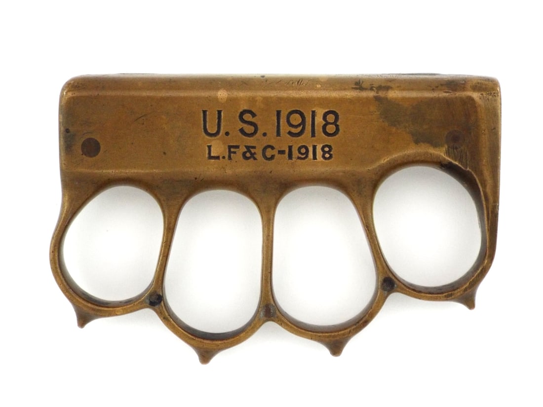 US Knuckleduster Made Out of The WWI LF&C Trench Knife: Cast brass knuckleduster hilt salvaged from a standard issue combat knife, the double edged steel blade missing with remnants of the steel tang permanently wedged inside the upper and lower slot cavit
