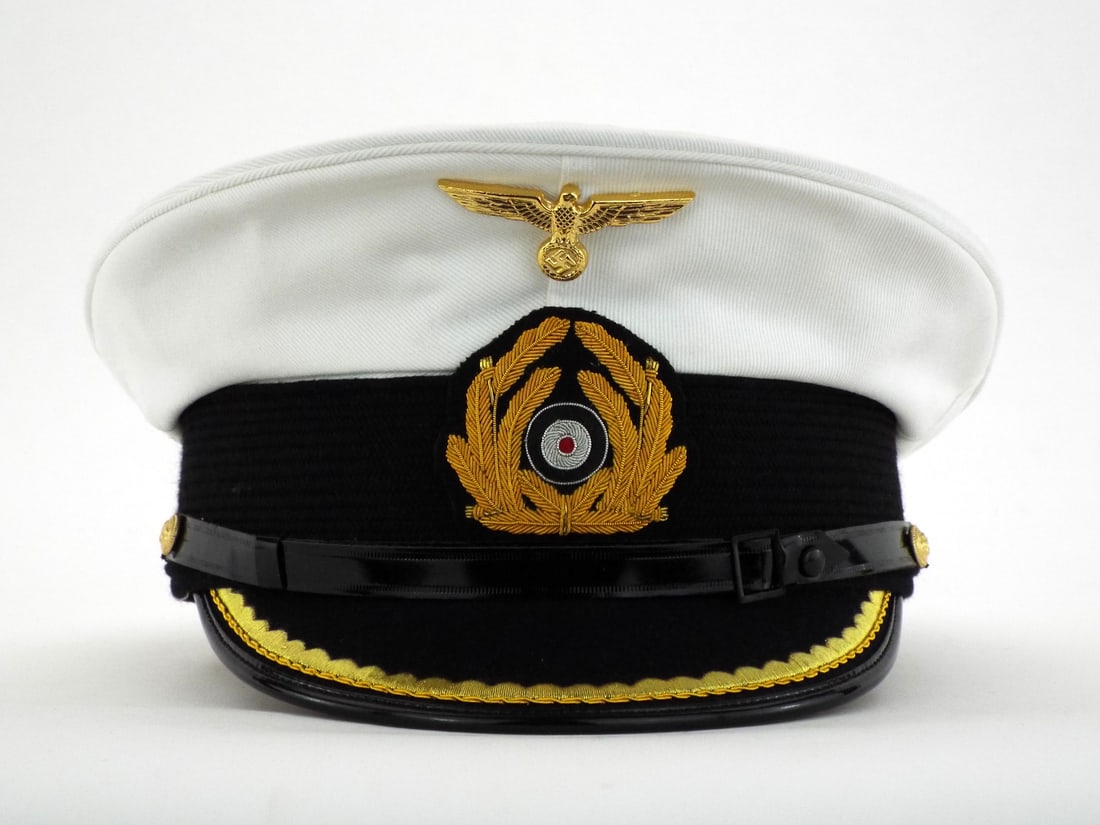 Very Good Quality German Made POST WWII KRIEGSMARINE U-Boat Officer Visor Cap: High grade production featuring white cotton twill cover over stiffened frame showing minimal storage wear. Gilded metal eagle and embroidered bullion wreath remain bright and well seated. Visor exhib