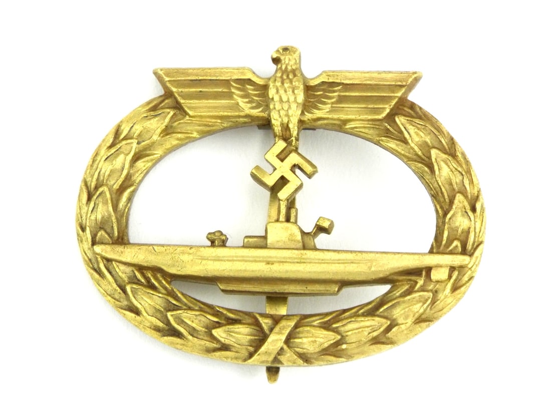 German WWII U-Boat War Badge Medal By FRANK & REIF STUTTGART: Die struck body retains excellent, crisp details with prominent gilt finish showing light high point wear and a pleasing aged patina. Reverse features an intact, solid vertical pin and catch assembly,