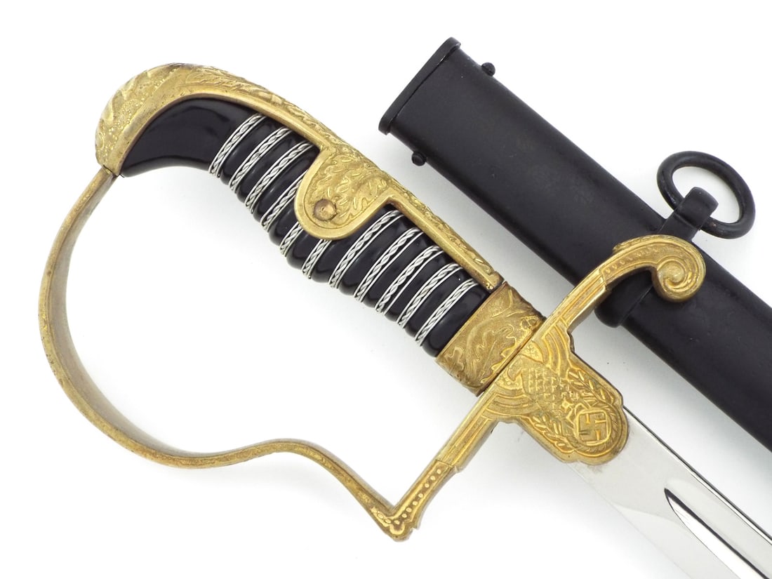 Private Purchase German WWII Officer Sword By EICKHORN Dove Head Pommel: Crisp Nickeled steel blade retains high bright polish with light runner marks, single fullers and maker squirrel trademark stamped at the ricasso. Cast brass dove head hilt displays strong gilding wit