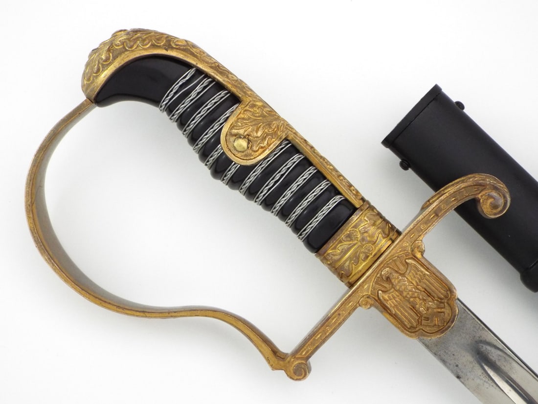 Private Purchase German WWII Officer Sword By EICKHORN Gilt Oak Leaf Hilt: Single edged nickeled steel blade features light runner wear, mild surface patina and a clear stamped squirrel maker mark with Solingen location on the ricasso. Gilt brass dove head hilt displays age 