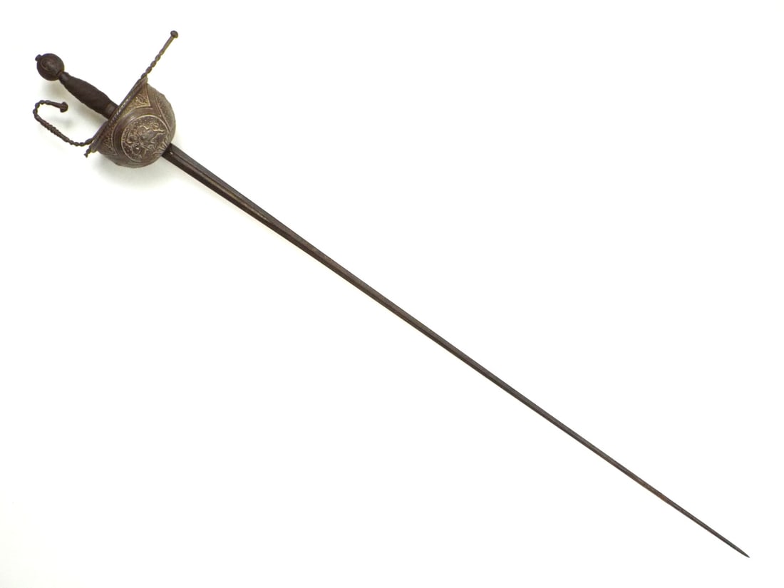 Spanish 17th C. Rapier Sword By GONZALEZ TOLEDO with Repousse Cup Hilt: Diamond cross section blade exhibits dark oxidized patina and surface wear, the fuller inscribed with maker name. Solid guard features a deep repousse cup depicting classical figures and beasts with u