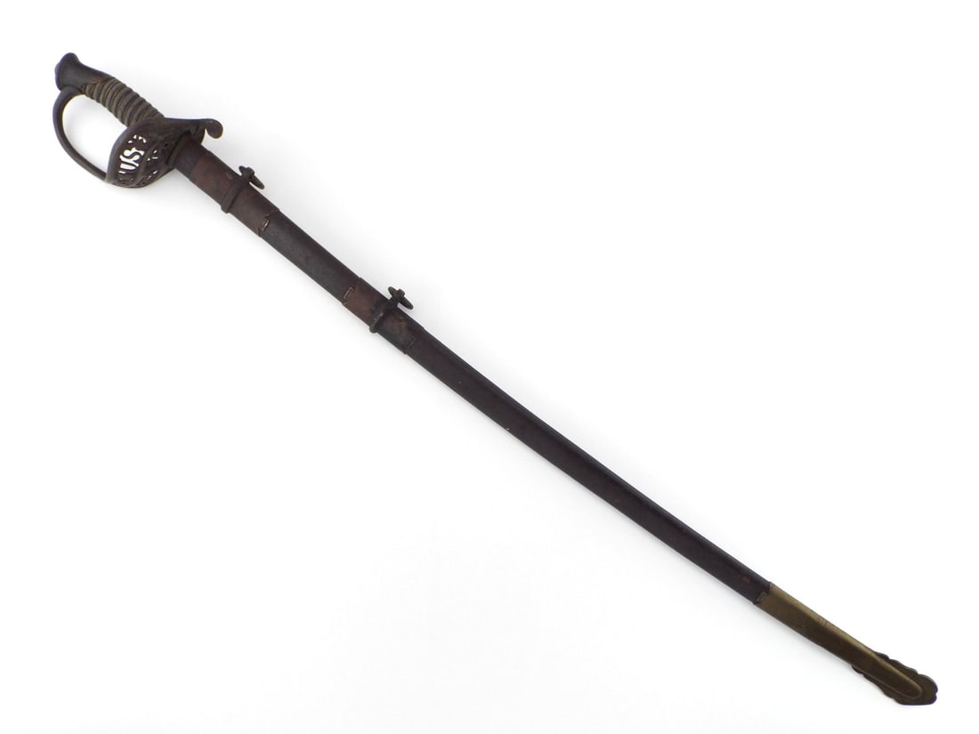 US Civil War Staff & Field Officer Sword with PIERCED BRASS GUARD: Steel blade shows light surface graying, faint etching displaying a US monogram alongside an eagle with E Pluribus Unum banner. Cast brass guard exhibits dark aged patina and intricate openwork foliat