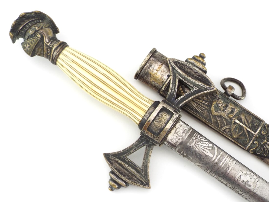 High Quality US Knights Templar Fraternal Sword By W.H. HORSTMANN & WKC SOLINGEN: Engraved blade displays masonic iconography with Philadelphia address and WKC crown mark, showing scattered oxidation and surface darkening. Very Fine fluted grip remains intact with yellowed patina,