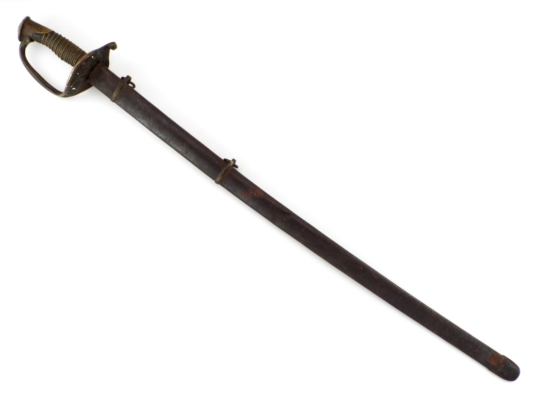 US Civil War Infantry Officer Sword FRENCH MADE with Horn Grip: Single edged, slightly curved steel blade shows prominent dual fullers with extensive dark patina, the spear point tip remains crisp. The asymmetrical brass guard features pierced floral decorations e