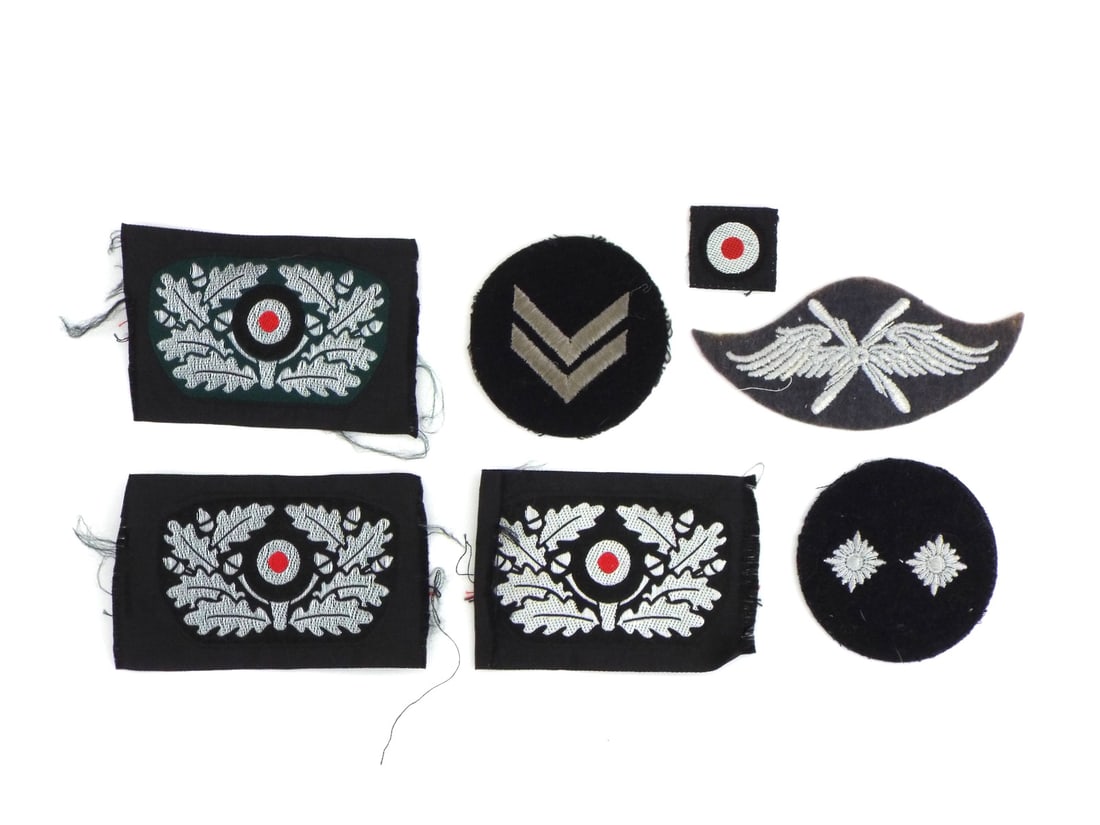 Group of German WWII HJ Insignia BeVo Embroidery & RZM Labels: Group consists of woven silk and cloth uniform patches featuring light surface fraying, clean stitching and vivid colors. Three embroidered cap wreaths and small cockade display minor edge wear withou