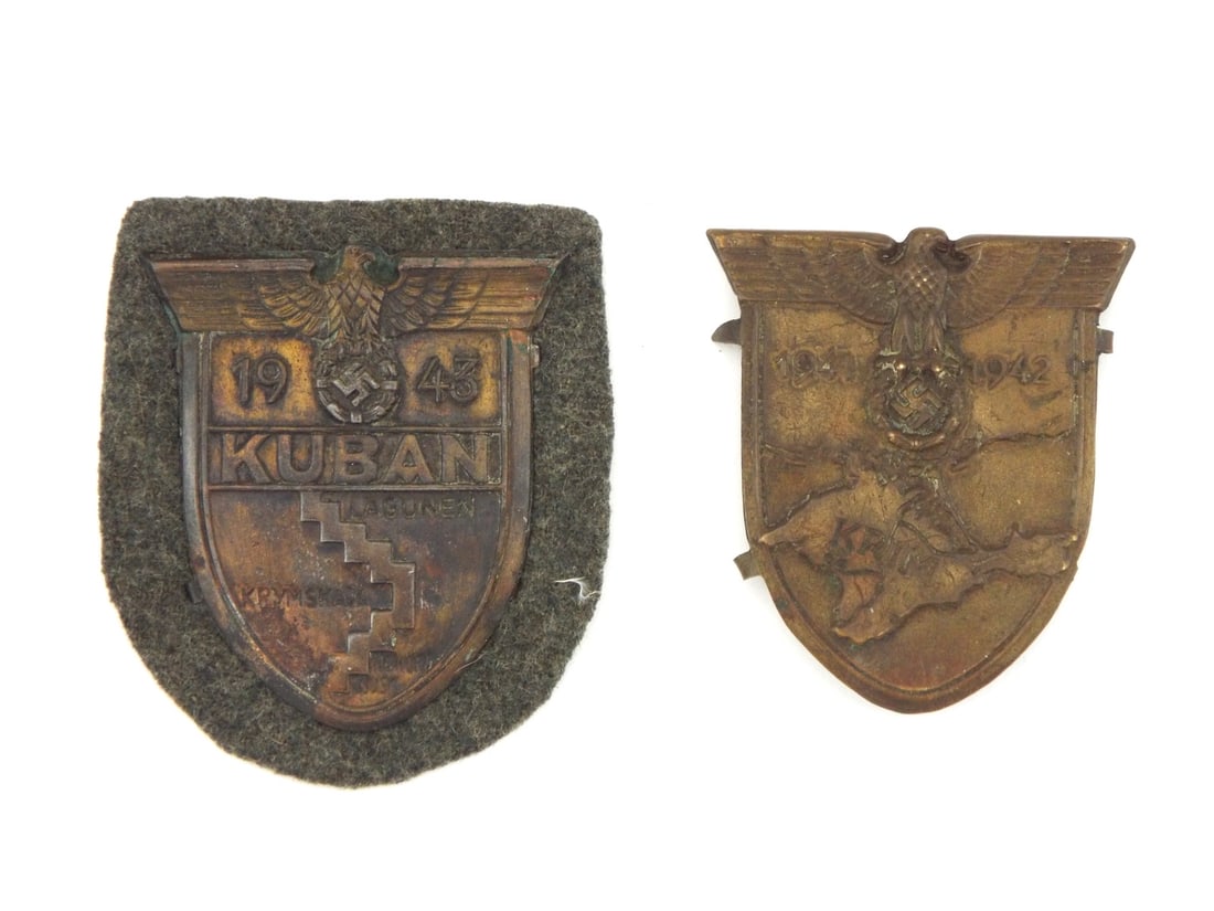Pair of German WWII KUBAN and CRIMEA Campaign Shields: Stamped sheet metal shield pair displays uniform dark patina, the green-gray wool backing with steel backplate campaign shield retaining its zinc toned map reliefs and eagle motifs while the Crimea ca