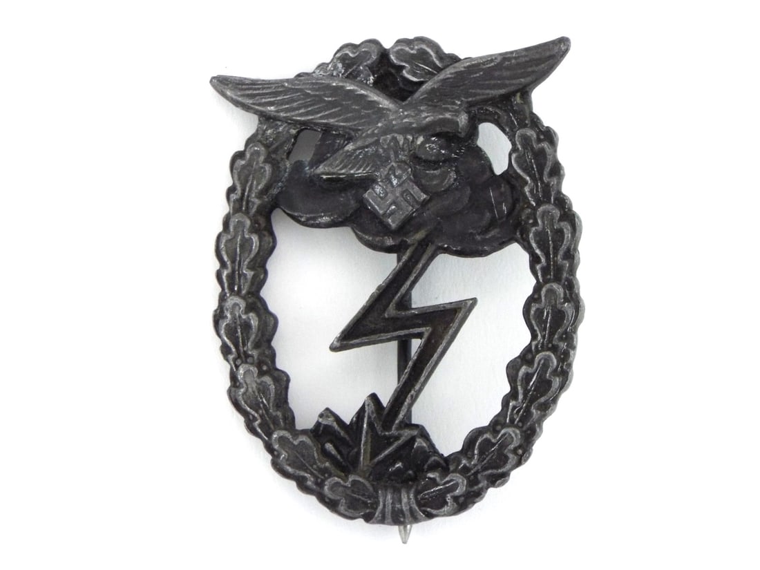 German WWII Luftwaffe Ground Combat Badge By G.H. OSANG DRESDEN: Award medal body displays dark, uncleaned aged zinc patina with minor softening to the high point details of the eagle and lightning bolt. Reverse features a vertical round pin, functional barrel hing