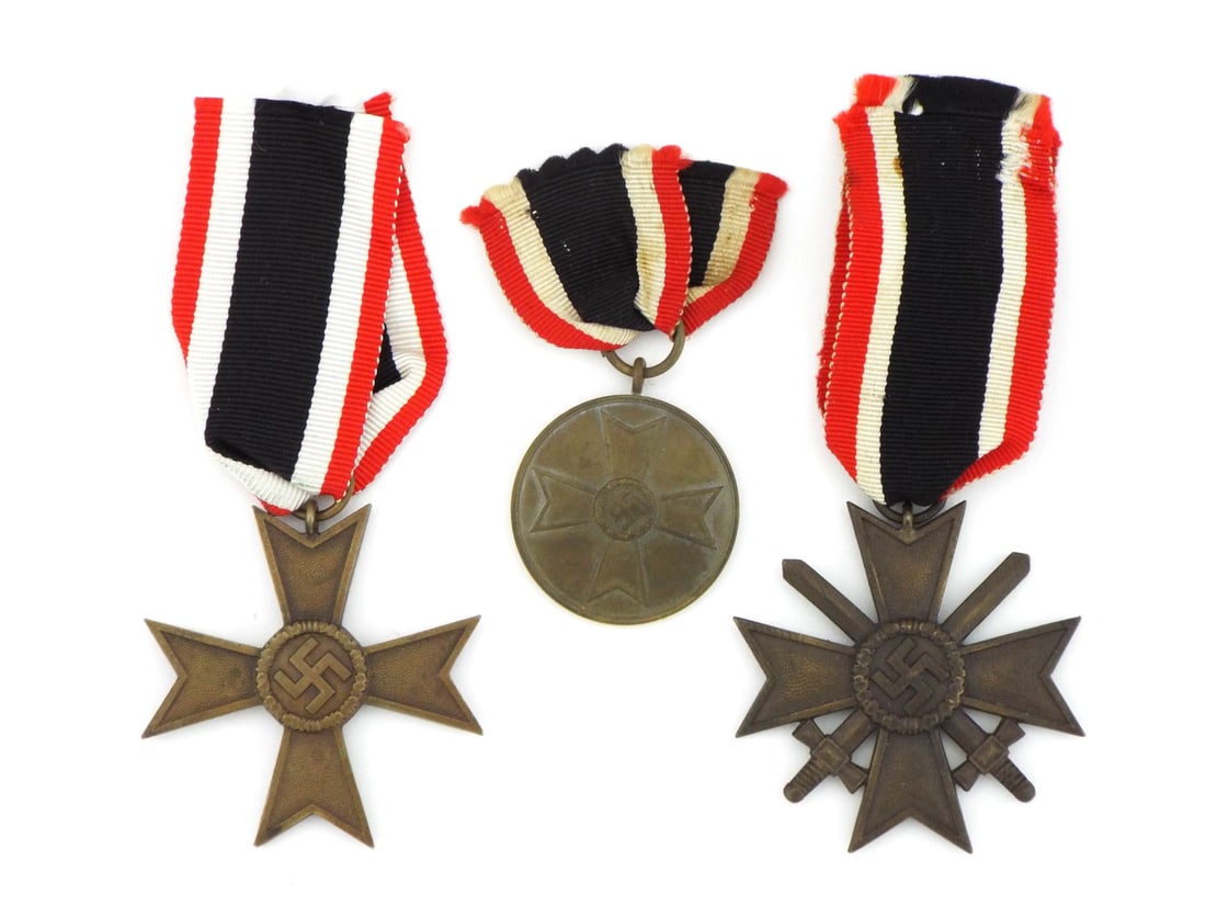 Trio of German WWII War Merit Medals with RIBBON Suspensions: Lot of three award medals including a 2nd Class with swords, a 2nd Class without swords and a circular medal, all exhibiting smooth aged patina with uniform light surface wear and crisp die details, t