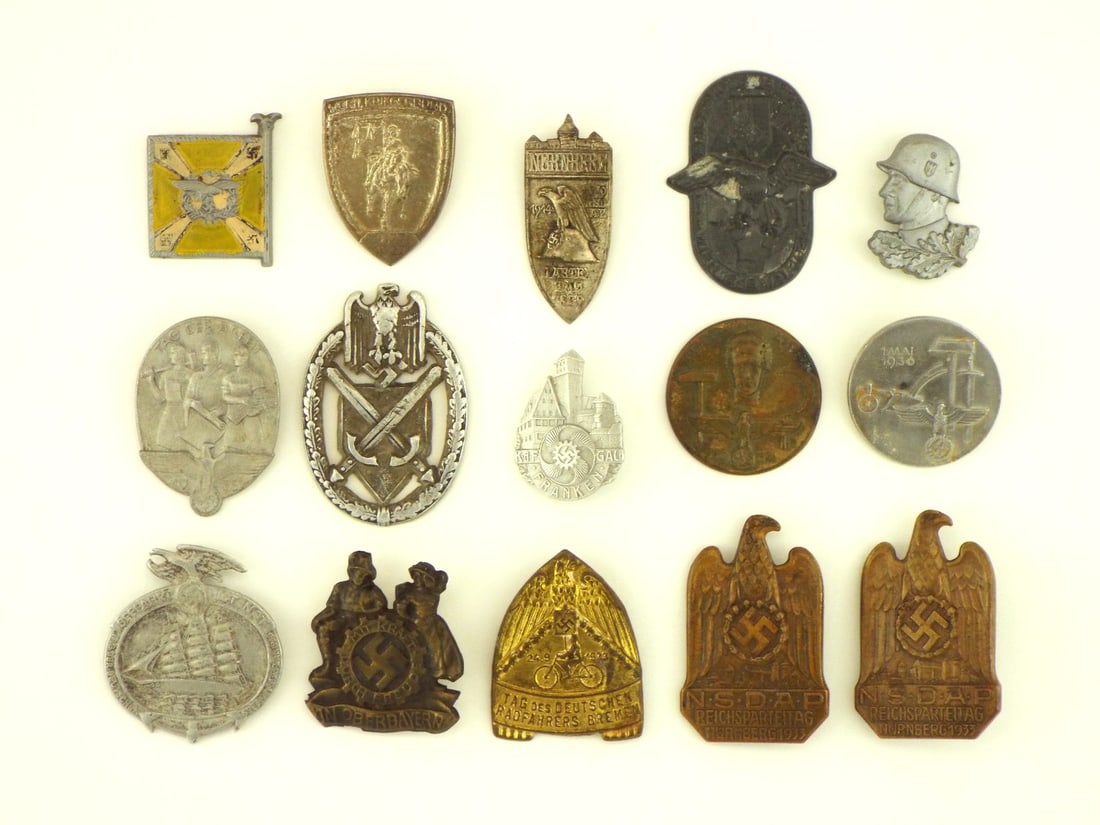 Grouping of 15 German WWII Political & Civic Tinnies & Badges: Grouping of 15 political and civic event badges retains solid overall condition with light surface wear and aged tone. Stamped hollow zinc and brass bodies feature sharp relief details, including a 19