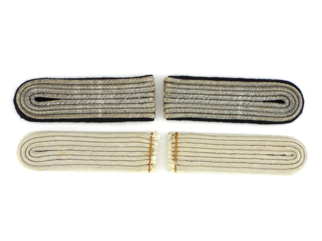 German WWII HEER & WAFFEN-SS Officer Shoulder Boards Silver Bullion: German WWII Infantry and SS officer shoulder boards feature matte silver aluminum braid over white and black wool underlays. Heer shoulder boards displays white wool backing with orange production thr