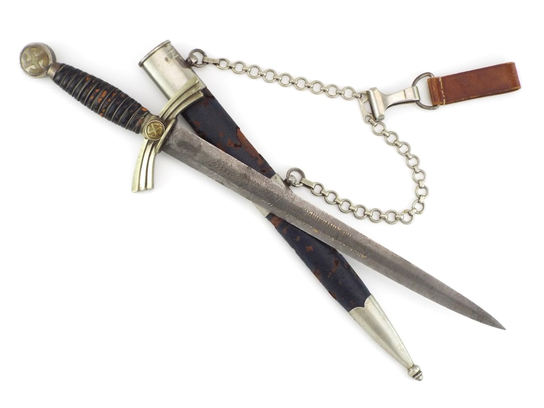 German WWII Luftwaffe Dagger PRESENTATION DAMASCUS Blade By RICH. PLUMACHER SOHN: Acid etched Damascus Pattern steel blade shows minor surface oxidation, displaying a personalized presentation inscription translating to For special bravery in aerial combat alongside a facsimile sig