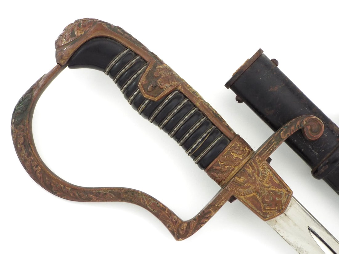 German WWII Army Officer Sword Gilt Brass Dove Head: Heer officer dress sword featuring a single edged polished steel blade exhibiting running fullers. Brass hilt assembly displays dark age patina featuring an embossed Wehrmacht eagle on the obverse lan