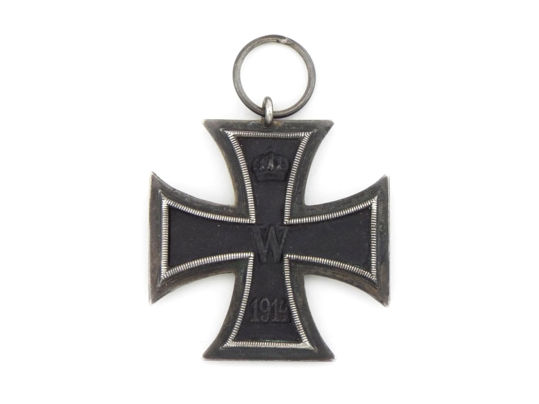 German WWI Iron Cross Medal 2nd Class: Three piece construction medal exhibits an iron central core surrounded by a silver frame displaying dark toning and age patina. Obverse shows the royal crown, central W monogram and 1914 date, while 