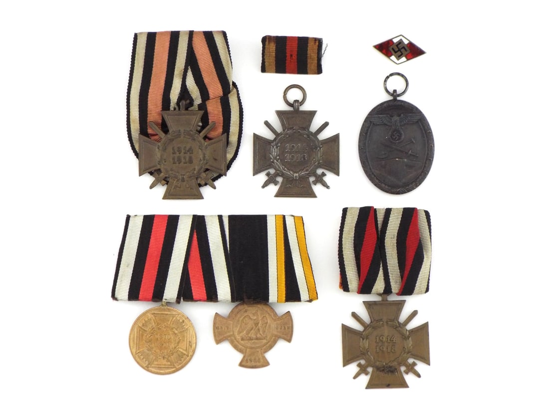 German Imperial Franco-Prussian & WWI MEDAL GROUPING: Grouping of awards including 1866 campaign cross, 1870-1871 campaign medal, three honor crosses with swords, West Wall defense medal, HJ pin and ribbon bars. Planchets display age tone, dark patina an