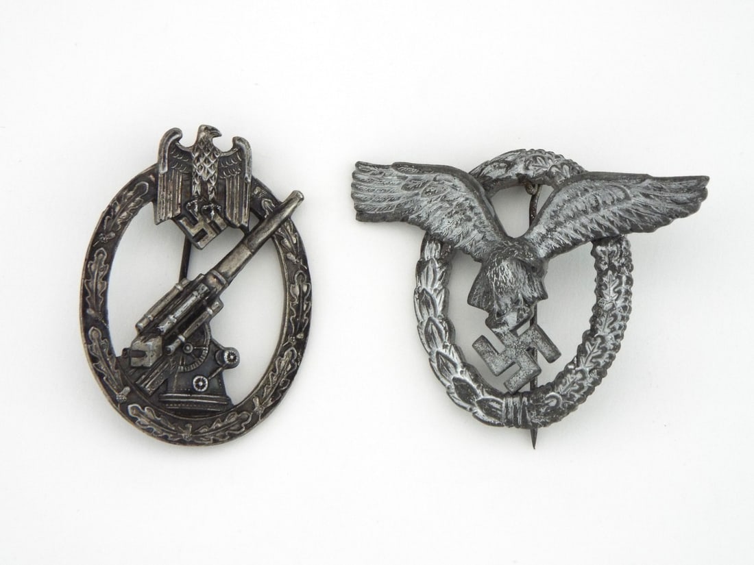 German WWII Army Flak & Luftwaffe Pilot Badges: Pair of army and air force combat decorations comprising a Flak artillery badge and a pilot badge. Obverses exhibit a dark, untouched aged patina with moderate surface wear across high relief features