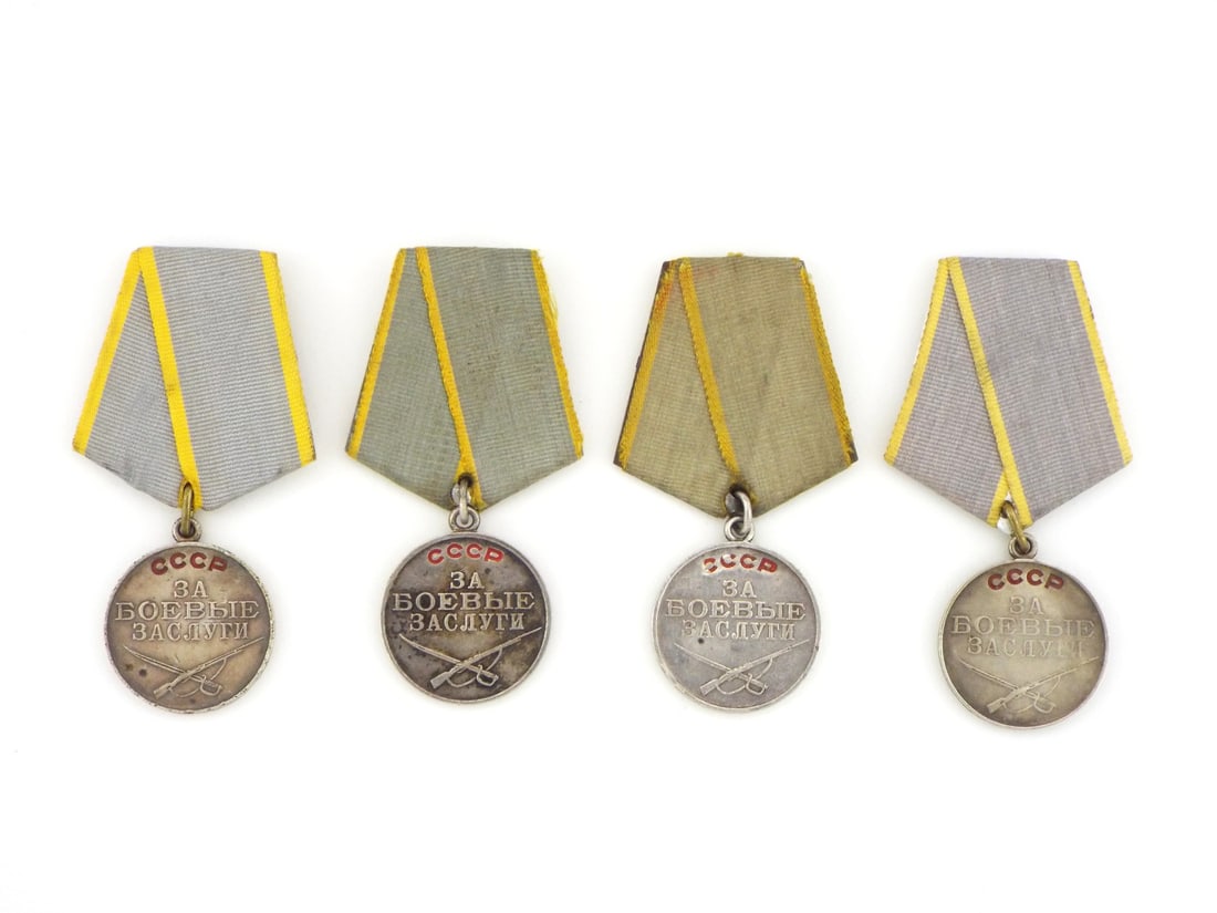 Soviet WWII Period Lot of 4 Silver Medals FOR BATTLE MERIT: Lot of four silver award medals with red enamel lettering reading USSR and For Battle Merit, showing light surface wear, minor toning and typical handling marks. Suspended from five sided aluminum rib