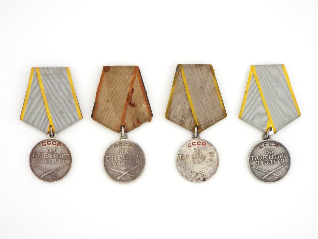 Group of Four Soviet WWII Period Medals For Combat Merit In Sterling Silver: Group of four campaign medals features silver planchets exhibiting moderate edge wear, toning and light surface contact marks, with clear stamped serial numbers 1171047, 1557538 and 1582608, suspended