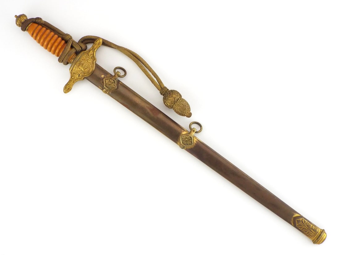 Spanish WWII Era Francoist Air Force Officer Dagger By FNT TOLEDO with Knot: Double edged steel blade bears FNT Toledo maker mark with light surface graying and minor staining. Brass crossguard displays detailed Spanish Air Force winged insignia on obverse with national coat o