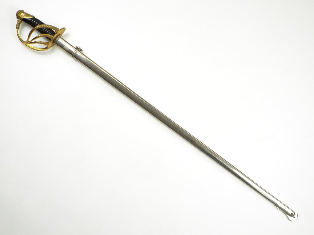 Belgian WWII Infantry Officer Sword By JULES FONSON BRUXELLES with Blade Engravings: Straight single edged blade shows light patina with detailed foliate engraving translating to For King and Country beneath the royal monogram of King Leopold III. The ricasso is sharply struck with