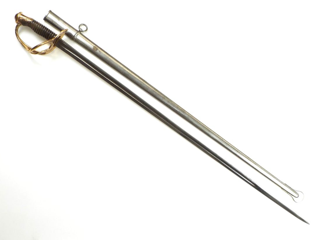 French Late 19th C. Cavalry Officer Sword By MANUFACTURE DARMES DE CHATELLERAULT: Bright single fullered blade shows light surface oxidation, backspine marked to May 1899 Chatellerault Arms Factory Cavalry Officer Model 1822. Gilt brass three bar guard exhibits fine leaf chasing