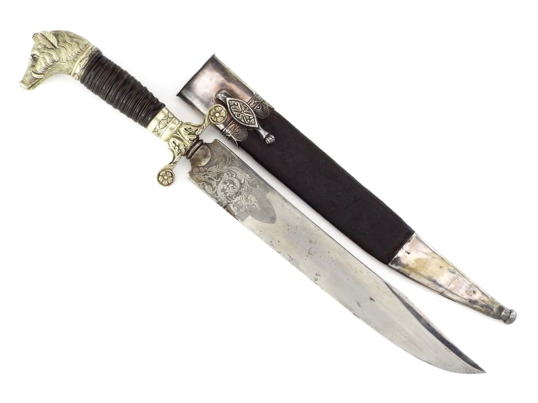 Extravagant German 18th C. NOBLEMAN HUNTING DAGGER Boar Head & Engraved Blade: Fine blade shows age consistent oxidation with fine decorative foliate engraving on both faces. The hilt features a cast metal wild boar head pommel over a ribbed dark wood grip and recurved crossguar